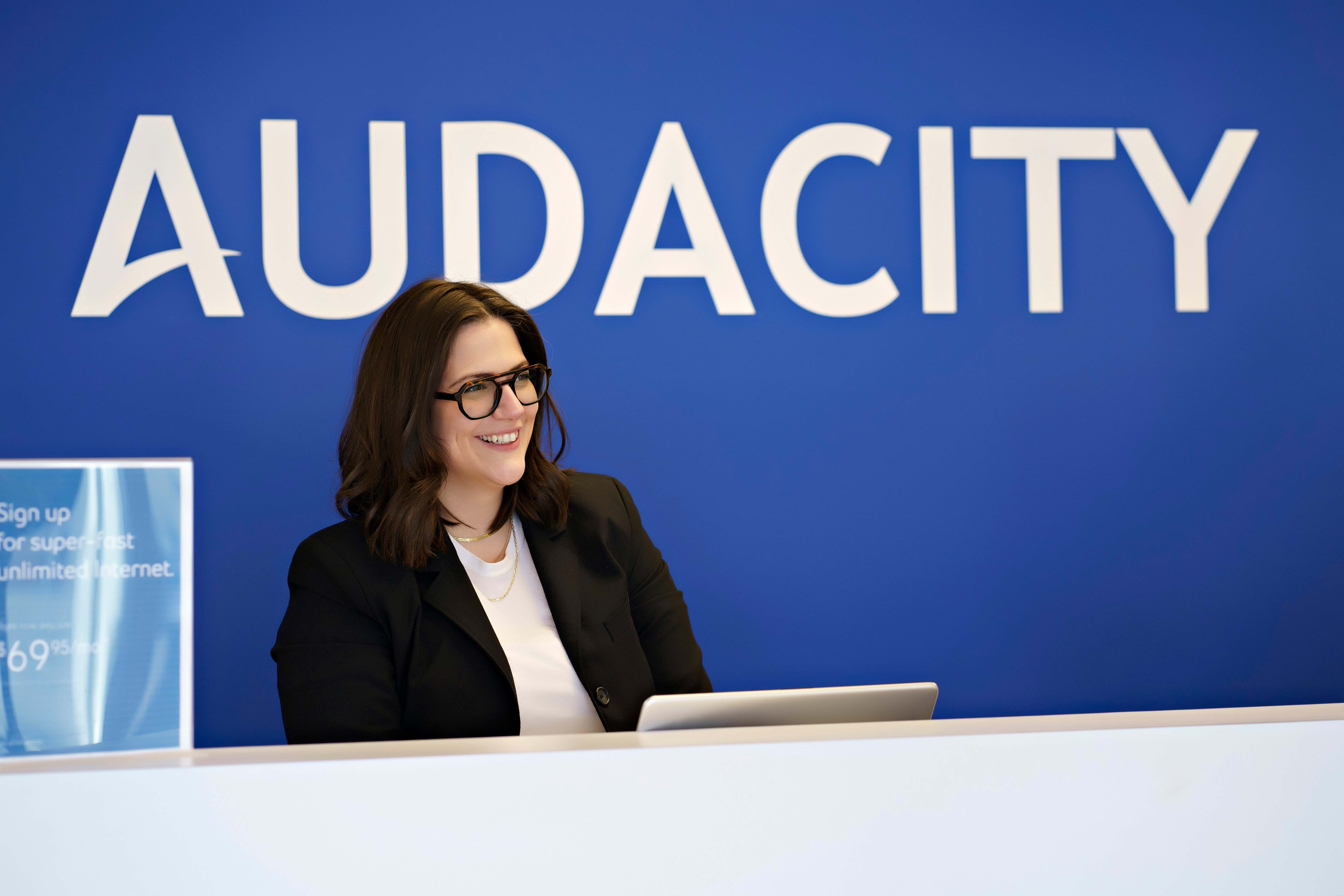 Audacity Wireless team member assisting a customer at a retail location